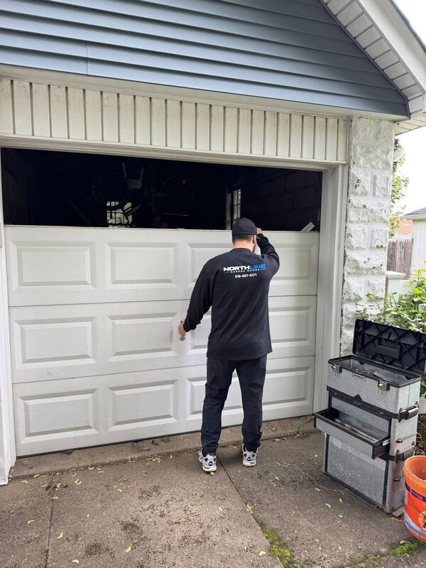 NorthLine technician working on a residential garage door