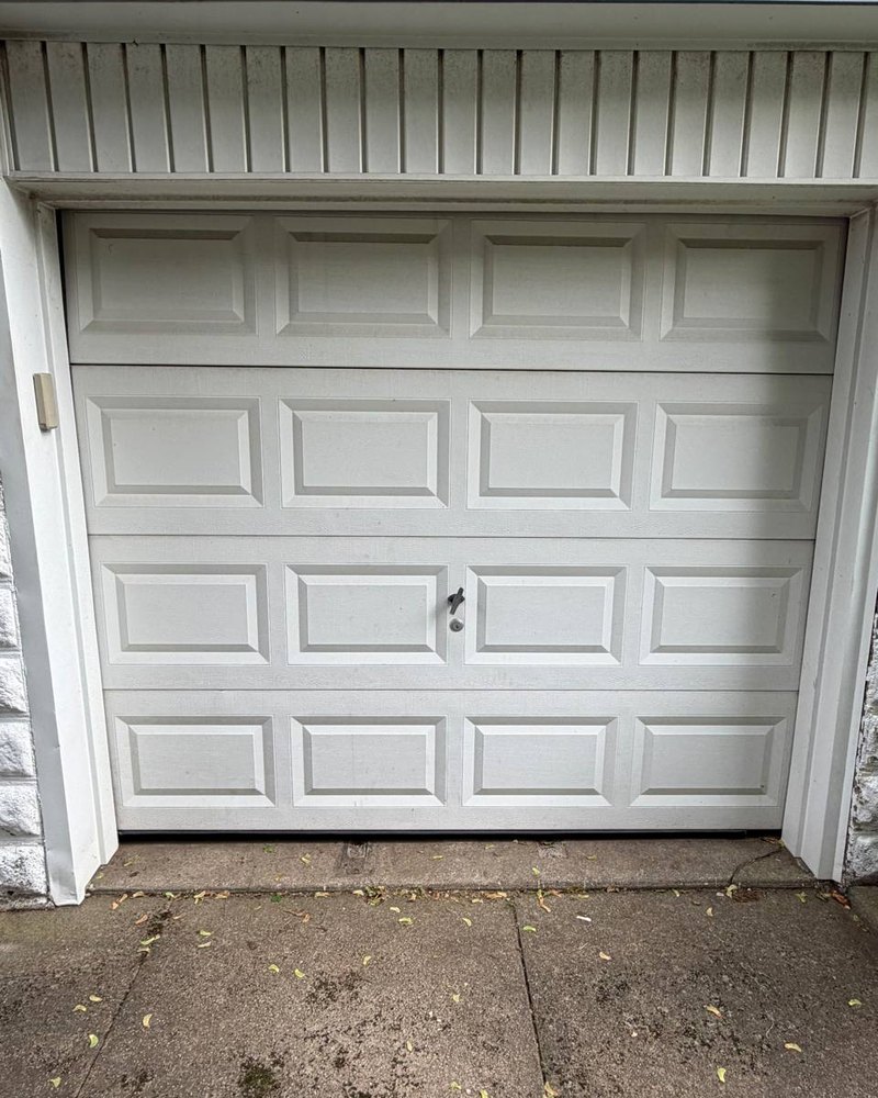 Residential garage door before service &mdash; NorthLine Garage Doors