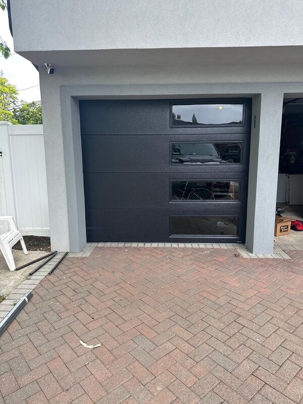 Charcoal garage door with a column of windows on one side